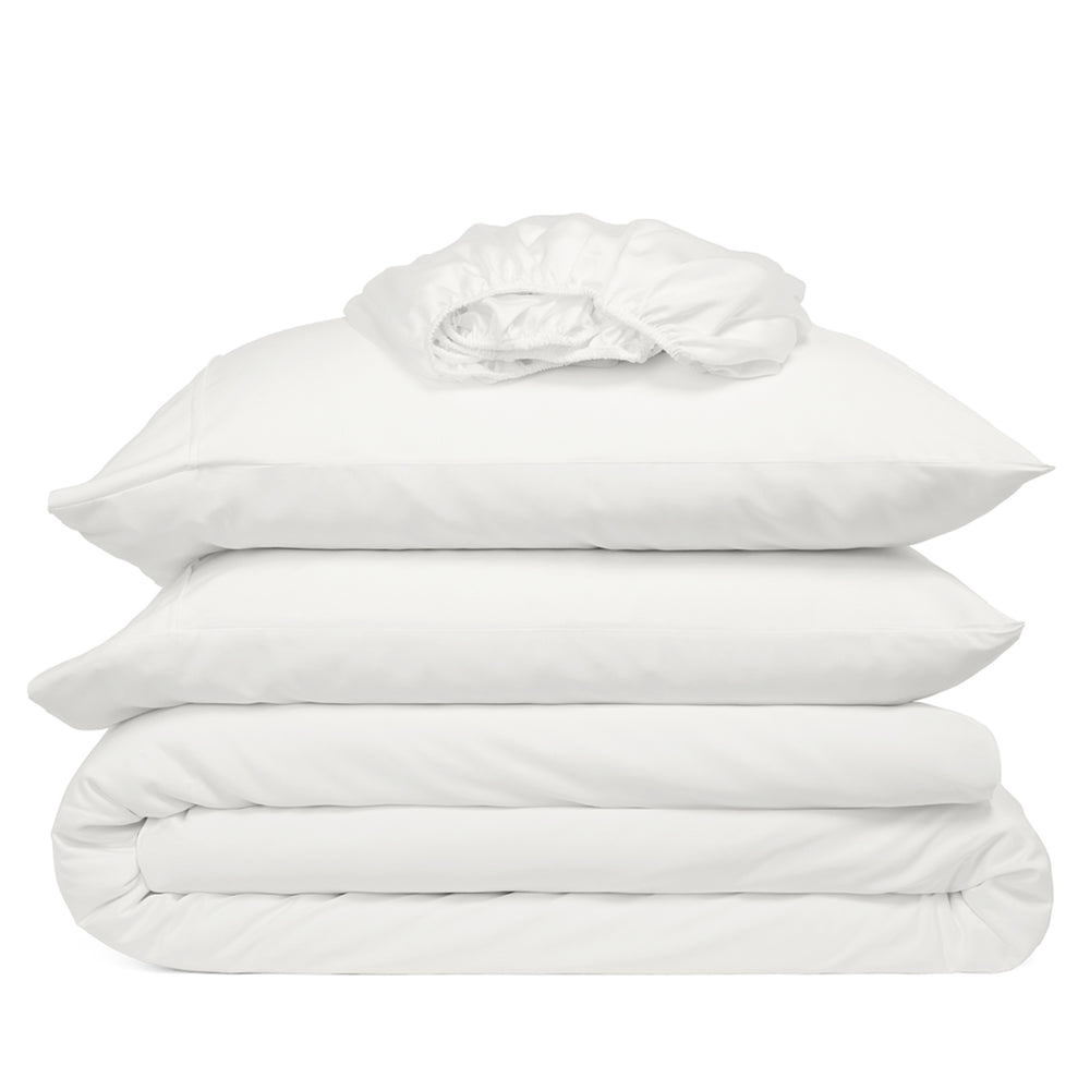 White bedding set including duvet, pillowcases, and fitted sheet on a white background