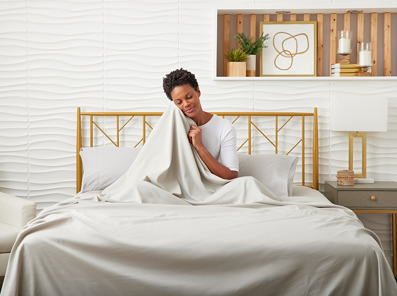 Female on a bed enjoying luxury bamboo sheets